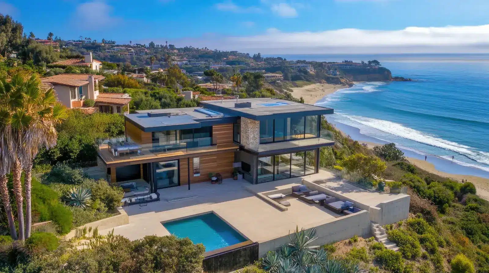 Modern home above the beach with a view of the coast