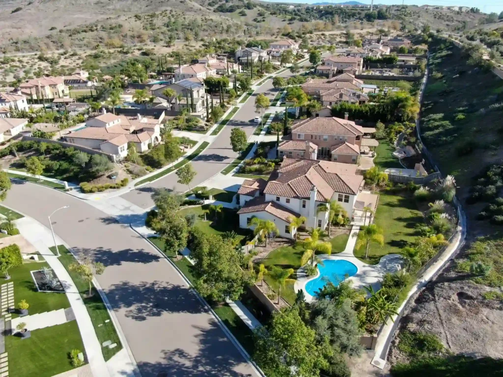 An aerial view of large homes on wooded lots in the hills